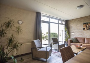 Atmospheric house with a fireplace in a holiday park in the woods