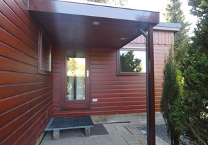 Beautiful wooden chalet for rent against forest