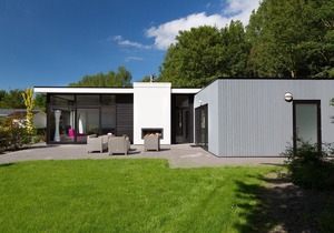 Modern chalet with a fireplace in a holiday park