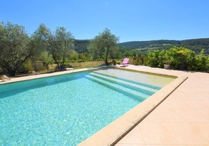 Rustic holiday home with large, shared pool and mountain views, in a charming location.
