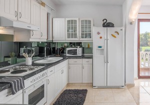 This Mediterranean vacation home with pool and beautifully landscaped garden is located in a settlem