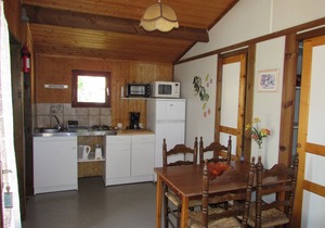 Wooden chalets in gite village with terrace, barbecue, swimming pool and air conditioning