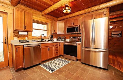 East Jordan Cabin | 5 BR log cabin - 40 private acres - Hiking trails