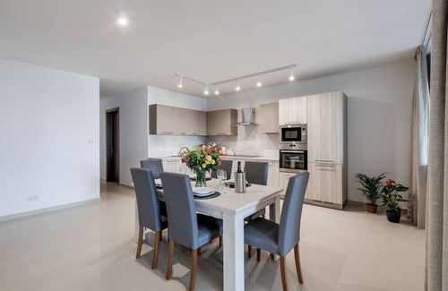Għadira Apartment | 🌴 9ten11 Maisonette – Ground-floor seafront stay with large patio, modern interiors & direct access to Mellieha Beach 🐚☀️ Perfect for families, couples & business trips.