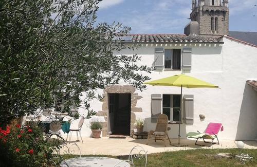 Bouin Cottage | a charming little house deep in a fenced garden with stone walls