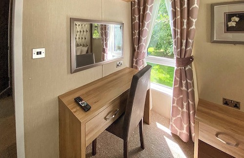 Langham House | A stunning lodge with one master double with en suite with bath and overhead shower.