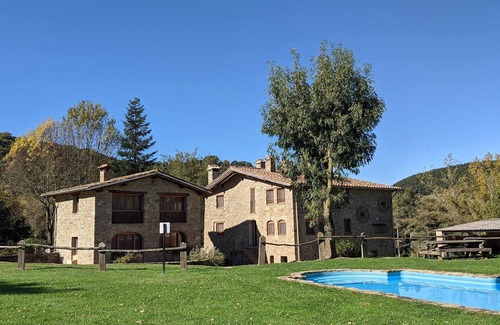 Santa Pau Apartment | Apartment 'Mas El Carrer - Blau' with Shared Pool, Shared Garden and Wi-Fi