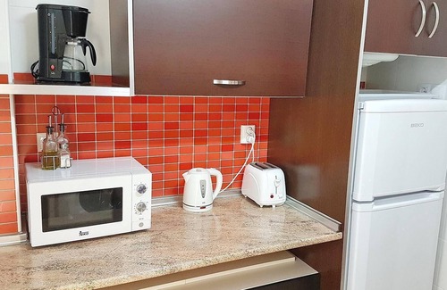 Orihuela Costa Apartment | Apartment with Large Roof Solarium, Pool, Garden, Barbecue, A/C & Wi-Fi