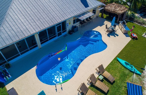 Stuart House | Aquatopia South: Riverfront Beach House, Steps 2 Ocean. Heated Pool & Dock!