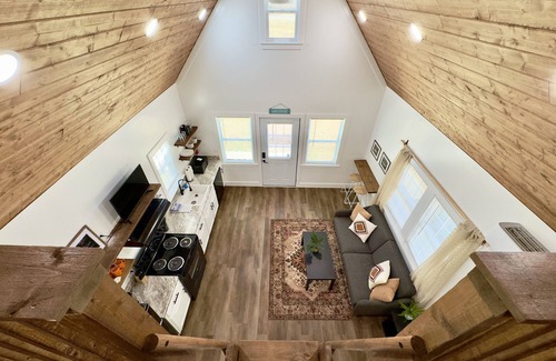Albertville Cabin | Bass Luxury Tiny Cabin on Lake with Jump Houses