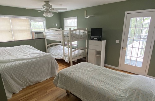 Gwinn Cottage | Beach front lake home, sleeps 8, hot tub, lots of outdoor spaces, docks.