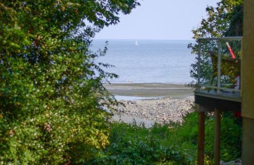 Courtenay House | Beachfront Cottage: Brick Fireplace + Ocean Deck