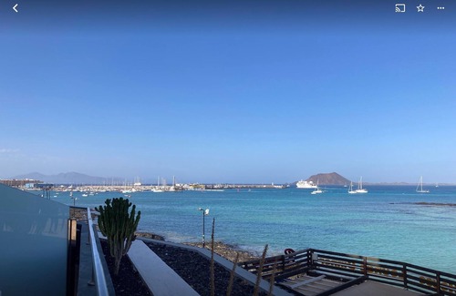 Corralejo Apartment | Beautiful Beachfront APTMTO at waters edge with stunning Ocean and Harbour views