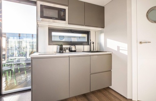 Volendam Boat Rental | Beautiful houseboat with shared pool