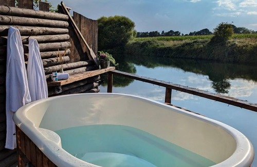 Washford Cabin | Bell tent in ultimate luxury with a wood fired hot tub, super king size bed