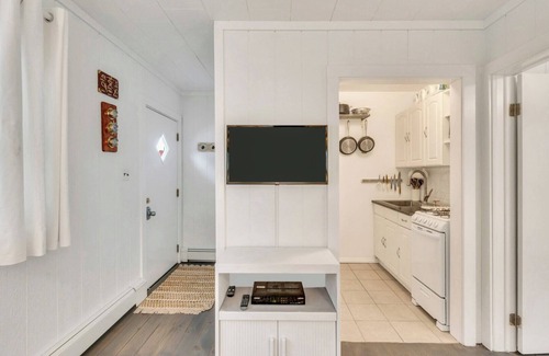 Montauk House | Bohemian-style hotel unit with ample natural light, a cozy seating area,.