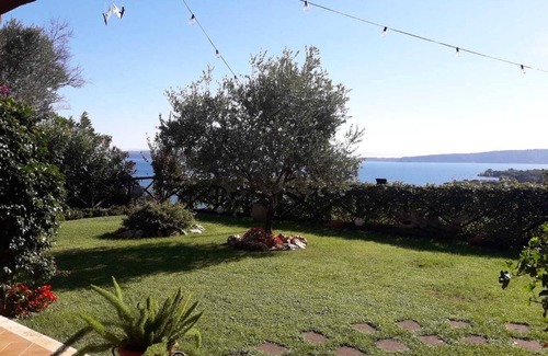 Lake Bracciano Villa | Breathtaking view of the lake and castle surrounded by holm oaks and oaks