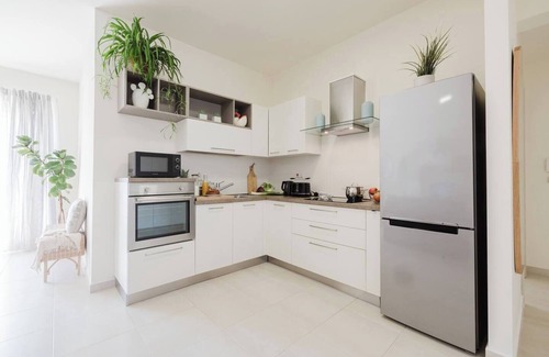 Ta' Pennellu Apartment | Bright and stylish 2-bedroom apartment in the heart of Mellieha, Malta. Located in a quiet residential area, it features a charming louvered balcony, large sunlit windows, and modern interiors with natural touches