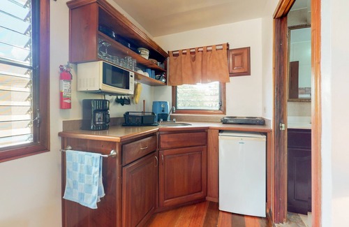 Hopkins Apartment | Cabana with a porch, hammock, & view of the pool & grilling area