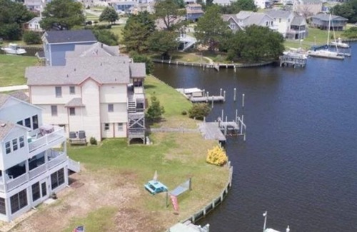 Colington Harbour House | Canal Front Home with Private Dock, Multiple Decks & Hot Tub