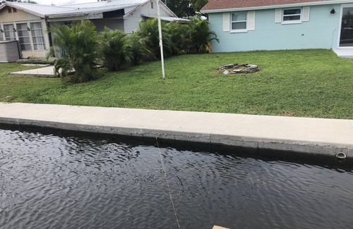 Hudson Beach Estates House | Canal front home walking distance to restaurants and small beach