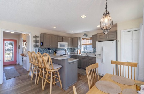 Colington Harbour House | Canalfront home w/wraparound decks and community amenities!