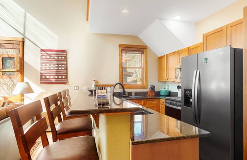 Keystone House | Centrally located with balcony, fireplace, heated garage parking & ski locker
