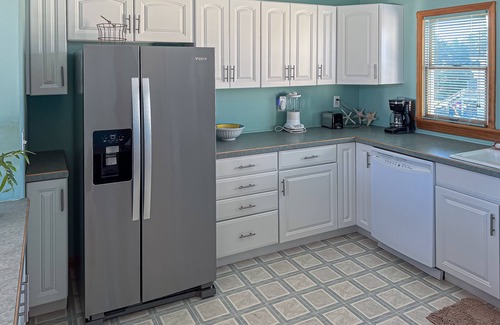 Colington Harbour House | Charming 4BR waterfront home with Private Hot Tub, Full kitchen, and WIFI