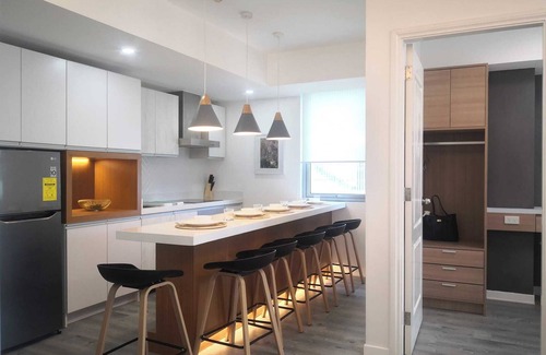 Don Bosco Resort | Charming family-sized condo at Azure Urban Resort with a grand wave pool!