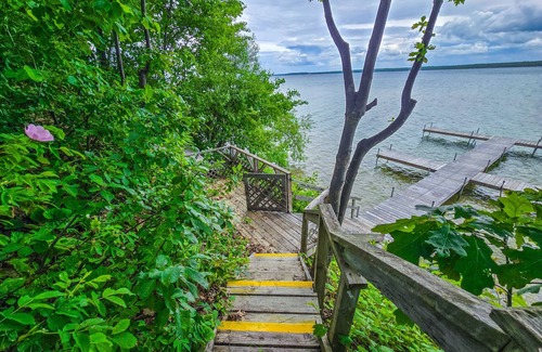 Indian River Cottage | Charming lakefront cottage with large yard, dock, & fire pit - close to downtown
