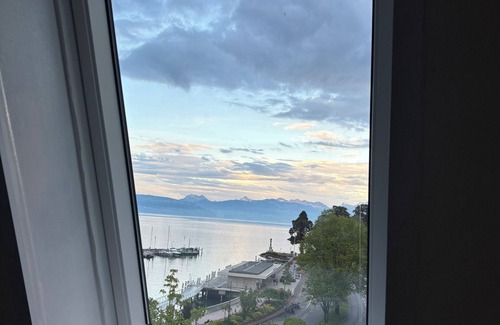Evian-les-Bains Apartment | Charming little studio with lake and mountain views from the bed.