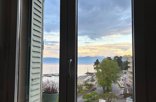 Evian-les-Bains Apartment | Charming little studio with lake and mountain views from the bed.