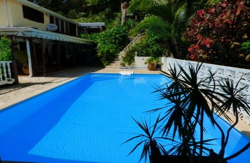 Les Abymes Apartment | Charming studio in a tropical garden. with swimming pool, free wifi and parking.