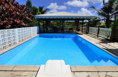 Les Abymes Apartment | Charming studio in a tropical garden. with swimming pool, free wifi and parking.