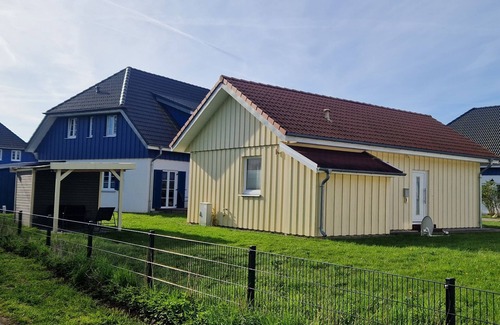 Altefaehr House | Close to the beach holiday home in a quiet field location with a spacious wooden terrace