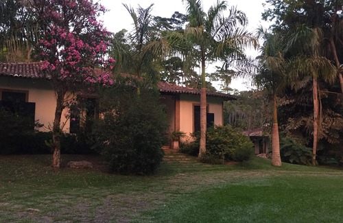 Correas House | Colonial house with a smaller house on the edge of a river and along the forest.