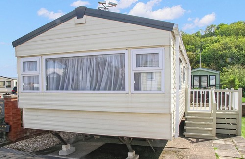 Gwespyr House | Comfortable 12ft-wide caravan with one double and one twin.