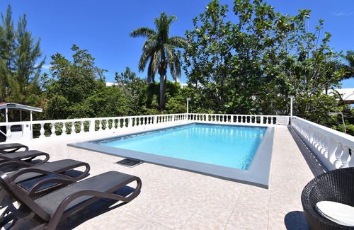 Mammee Bay Villa | Comfy bedrooms minutes away from beach, free WIFI, spa hut, BBQ,24-hour security
