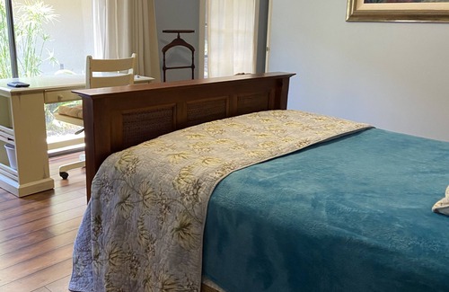 Hunt Club Bed & Breakfast | Country Garden Room with Water Garden feature and Queen Bed.