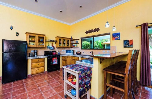 Junquillal House | Cozy 3-bedroom retreat in Tierra Pacifica with lush gardens, AC, hammock rancho, and full access to pool, gym, yoga room, and more.