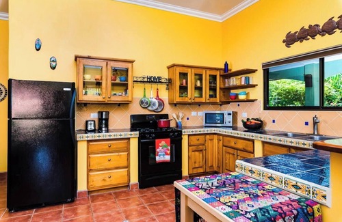 Junquillal House | Cozy 3-bedroom retreat in Tierra Pacifica with lush gardens, AC, hammock rancho, and full access to pool, gym, yoga room, and more.