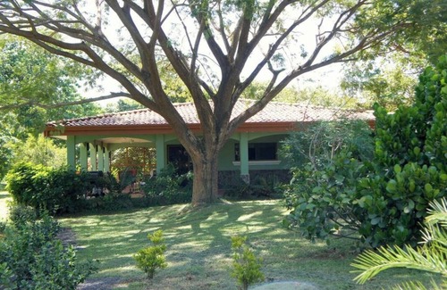 Junquillal House | Cozy 3-bedroom retreat in Tierra Pacifica with lush gardens, AC, hammock rancho, and full access to pool, gym, yoga room, and more.