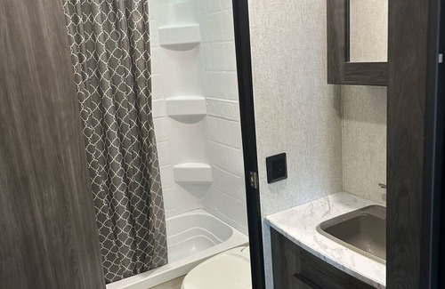 Dawson County House | Cozy camper with queen Murphy bed, bunks, and dinette conversion bed.