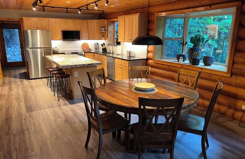 Snowbird Cabin | Cozy log cabin secluded in a mountain forest with hot tub, sauna, private patio.