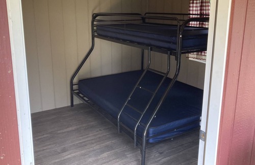 Front of Yonge RV Rental | Cozy solar Bunkie cabin located happy green acres campground