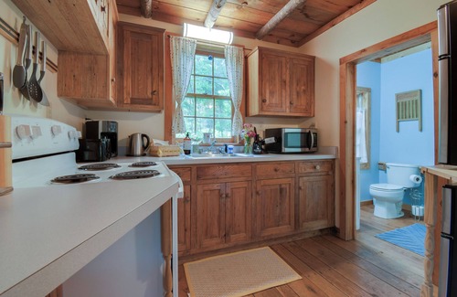 Raphine Cabin | Creekside historic log cabin w/modern amenities at historic Wade's Mill