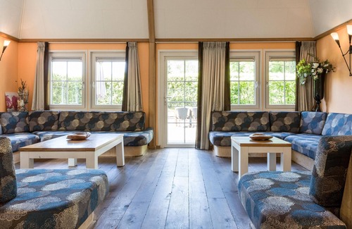 De Bult Villa | Designed home with bedstead, surrounded by forest