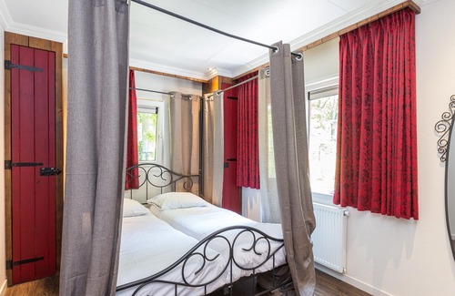 De Bult Villa | Designed home with bedstead, surrounded by forest