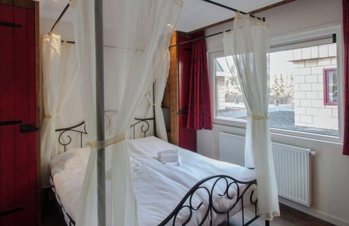 De Bult Villa | Designed home with bedstead surrounded by forest