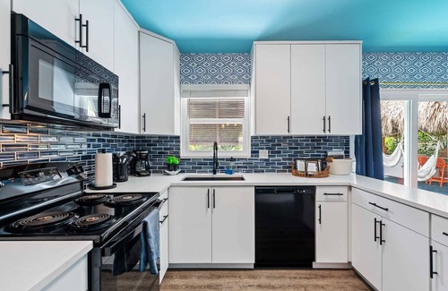 Garden Isles House | Eccentric home with pool, tiki hut & outdoor kitchen